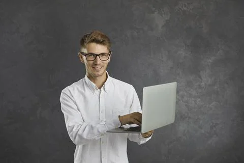Portrait of happy young programmer, office worker, student or freelancer working Foto stock