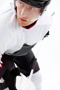 Portrait of healthy sportsman looking aside while playing hockey on ice Stock Photos