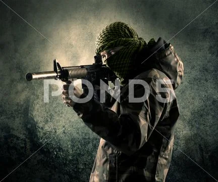 Portrait of a heavily armed masked soldier with grungy background Stock Photos