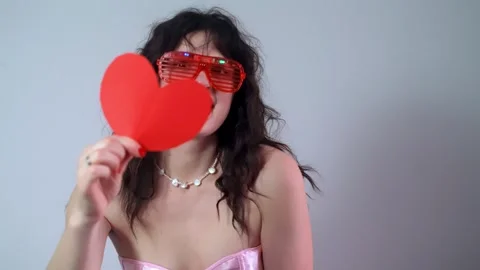 Portrait of her, she is attractive cute joyful kind girl holding big heart in he Stock Footage 298185053