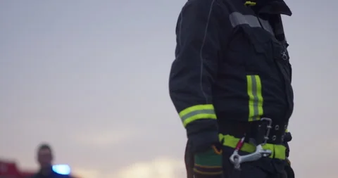 Portrait of a heroic fireman in a protective suit. Firefighter in fire fighting Stock Footage 282522761