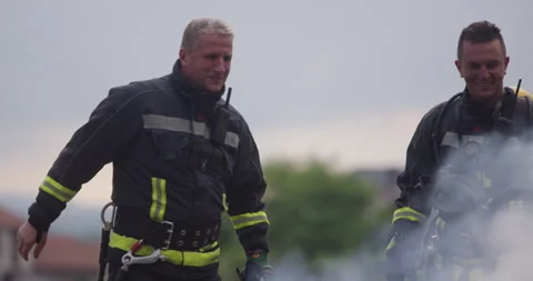 Portrait of a heroic fireman in a protective suit. Firefighter in fire fighting Stock Footage 283075752