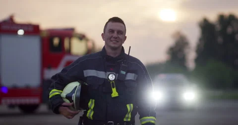 Portrait of a heroic fireman in a protective suit. Firefighter in fire fighting Stock Footage 283076736