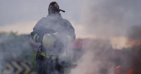 Portrait of a heroic fireman in a protective suit. Firefighter in fire fighting Stock Footage 283082011