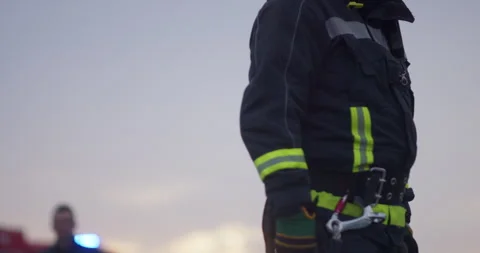 Portrait of a heroic fireman in a protective suit. Firefighter in fire fighting Stock Footage 283082263