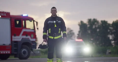 Portrait of a heroic fireman in a protective suit. Firefighter in fire fighting Stock Footage 283090311