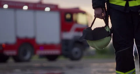 Portrait of a heroic fireman in a protective suit. Firefighter in fire fighting Stock Footage 283094339