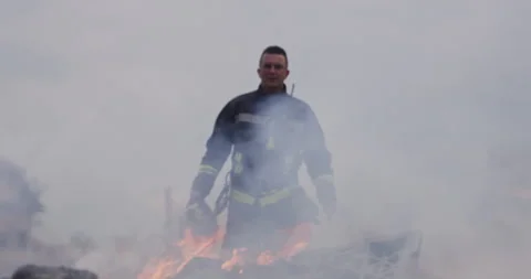 Portrait of a heroic fireman in a protective suit. Firefighter in fire fighting Stock Footage 283094750
