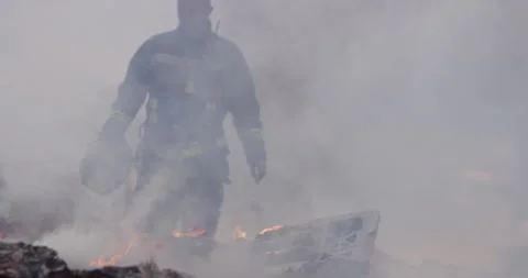 Portrait of a heroic fireman in a protective suit. Firefighter in fire fighting Stock Footage 283096922