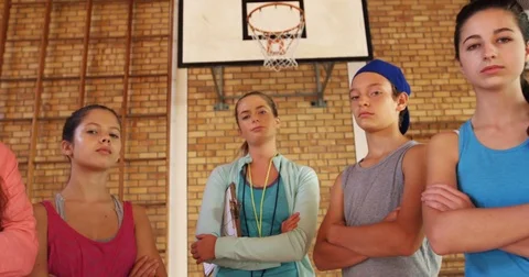 Portrait of high school kids and female coach standing with arms crossed Stock Footage