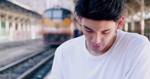 Portrait of hipster waiting for train in train station, with train in Stock Footage 106386108