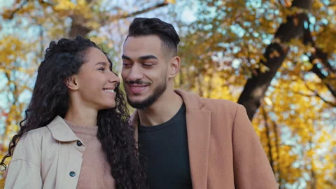 Portrait hispanic couple on date in autumn park attractive young woman huge Stock Footage 165879853