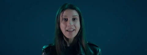 Portrait of Hispanic female showing a range of facial emotions against blue bg Stock Footage 254690930