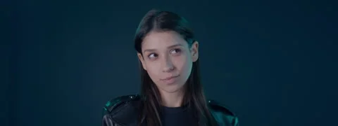 Portrait of Hispanic female showing a range of facial emotions against blue bg Stock Footage 254691347
