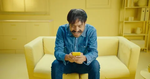 Portrait of Hispanic man with mustache looking at the mobile phone screen and Stock Footage 171372594