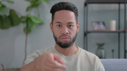 Portrait of Hispanic Man Pointing at Camera at Home Video stock 293258934