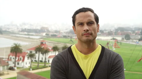 Portrait of a Hispanic man standing on a cliff in front of the pacific ocean on Stock Footage 44068586