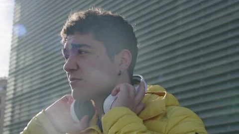 Portrait of hispanic young man taking off headphones Stock Footage 222569940