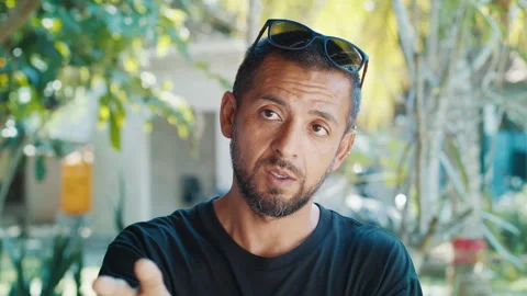 Portrait of the hispanic young man talking and during interview with naturally Stock Footage 311872640