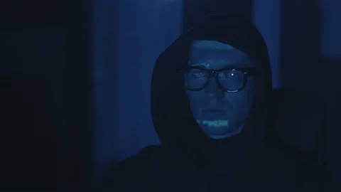 Portrait of hooded IT hacker programmer developer in glasses working computer Stock Footage 146776621