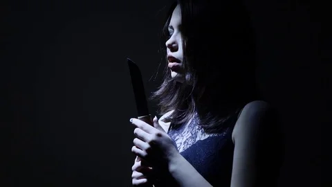 Portrait of a horror Halloween Scream inspired teen girl with a knife Stock Footage