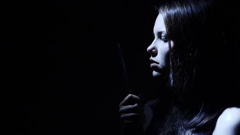 Portrait of a horror Halloween Scream inspired teen girl with a knife Stock Footage 80604845