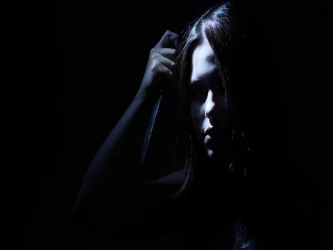 Portrait of a horror Halloween Scream inspired teen girl with a knife Stock Footage