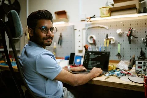 Portrait of Indian Engineer Programming on Laptop in Tech Workshop Stock Photos