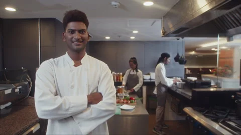 Portrait of Indian Executive Chef in White Uniform at Restaurant Kitchen Vidéo 257752779