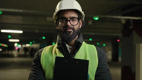 Portrait Indian man worker contractor mechanic guy in helmet and glasses posing Stock Footage 250453079