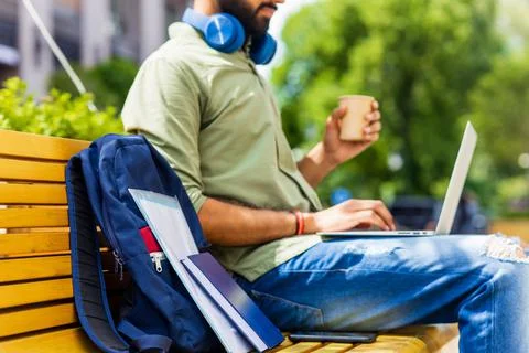 Portrait Indian student programmer using laptop computer in park 스톡 사진