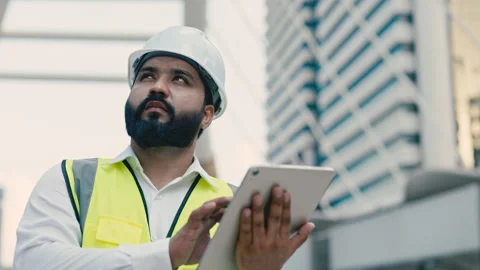 Portrait of Indian technician working on tablet at city construction site Video stock 312199971