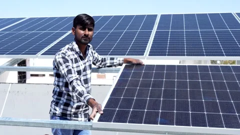 Portrait of Indian worker installing solar panels on roof of house. Mainten.. Stock Footage 270754344