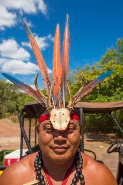 Portrait of Indigenous man wearing a hat made of feathers and carved wood, Ve Stock Photos