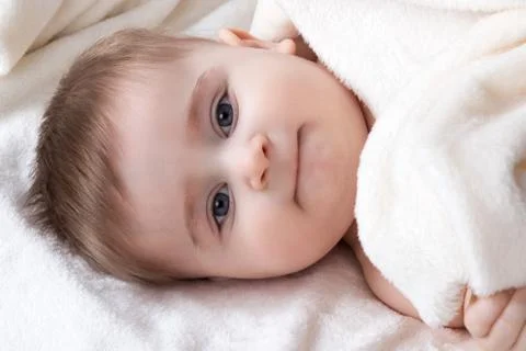 Portrait infant lying on the bed Stock Photos