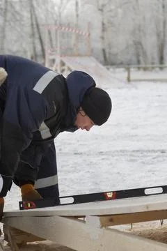 A portrait of an installer when working with a level 스톡 사진