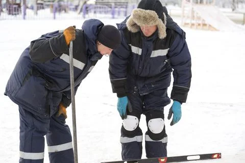 Portrait of installers when working with a level Fotos Stock