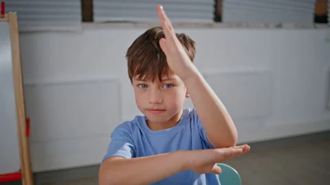 Portrait interested kid studying at elementary school. Cute boy raising hand Stock Footage 279567223