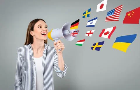 Portrait of interpreter with megaphone and flags of different countries on gr Stock Photos