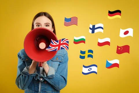 Portrait of interpreter with megaphone and flags of different countries on ye Stock Photos