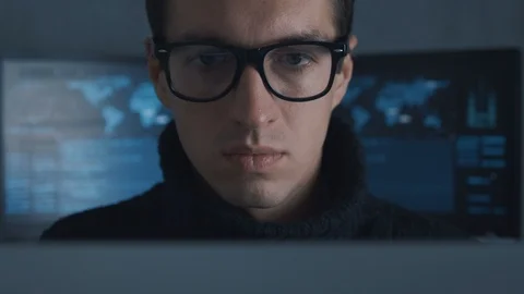 Portrait of IT professional programmer in glasses is working on computer in Stock Footage 100697745