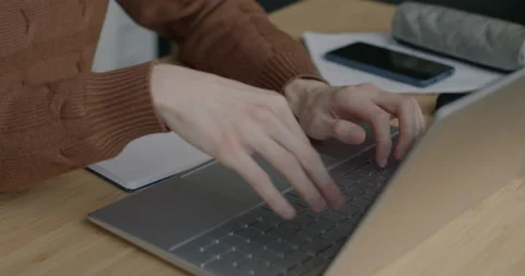 Portrait of IT specialist working with laptop typing and looking at screen at Stock Footage 237696024