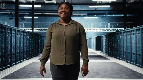 Portrait of jolly data center engineer overseeing IT equipment Stock Photos