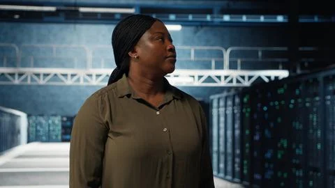 Portrait of jolly data center engineer overseeing IT equipment Stock Photos