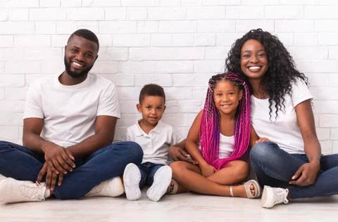 Portrait of joyful african american family with two little kids Stock Photos
