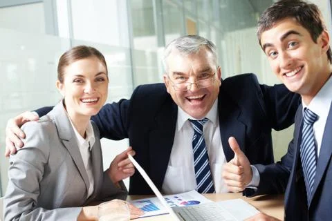 Portrait of joyful business group showing their gladness and looking at camera Stock Photos
