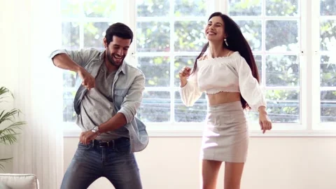 Portrait of joyful couple dancing while having fun at home together. Stock Footage 165721607