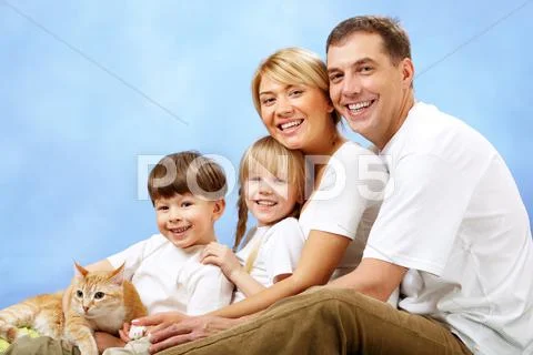 Portrait of joyful family looking at camera on blue background Stock-Fotos
