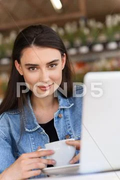 Portrait of a joyful lady with a cup of coffee Stock Photos