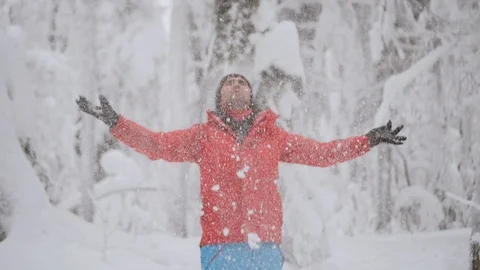 Portrait of joyful man in red jacket having fun, winter forest covered with snow Stock Footage 122425631
